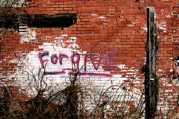 Forgive Graffiti stock photo