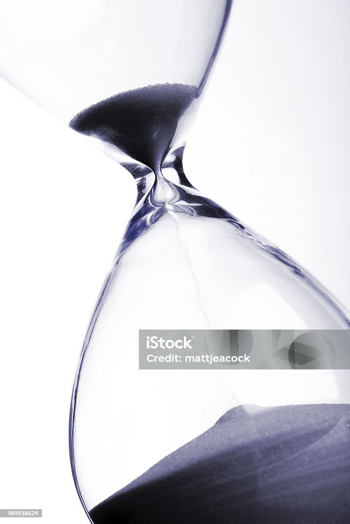 Running out of time Hourglass on plain background. Very shallow depth of field. Hourglass Stock Photo