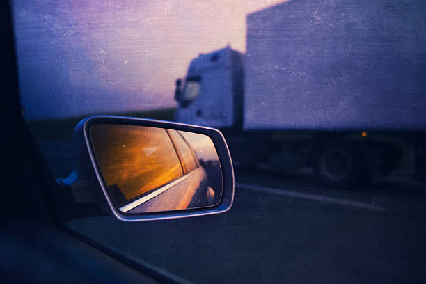istock rear view mirror and semi-truck on the highway 184938661