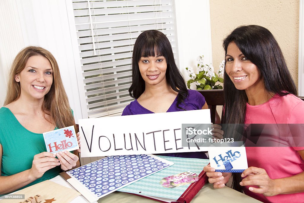 Volunteers:  Mixed-ethnic group of ladies creating cards for charity. Mixed-ethnic group of ladies volunteering.  They are making greeting cards to sell for a charity. Greeting Card Stock Photo