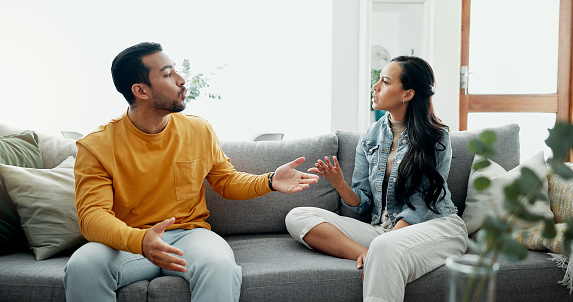 Conflict, angry fight and frustrated couple on a couch with drama, argument and toxic relationship in a home. Unhappy, divorce and man with marriage problem with woman and stress in living room sofa