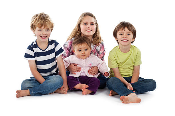 istock Four children sitting on white background smiling 184939770
