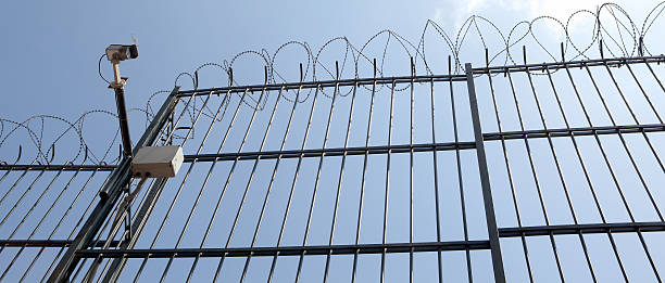 istock Barbed Wire Fence and CCTV Camera. 184939939