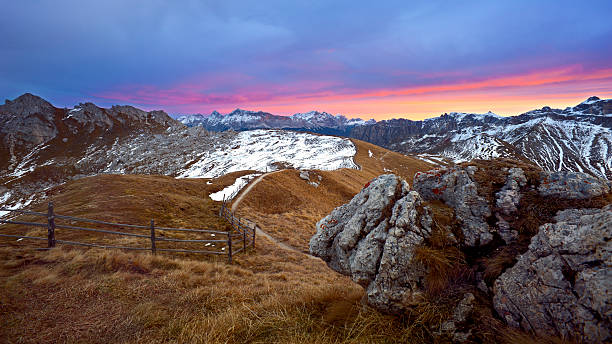 красочные небо в горы - country road fence road dolomites стоковые фото и изображения