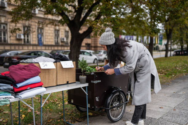 istock Woman writing prices while selling second hand items on street flea market 1849401046