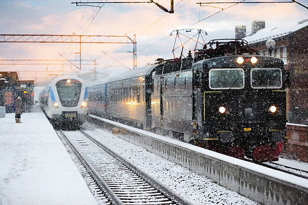 Snowy trains close to railway station platform