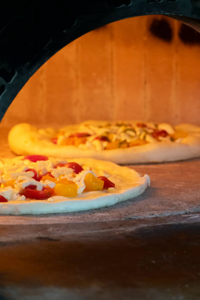 istock Gluten-free pizzas cooking in a wood-fired oven 1849403201