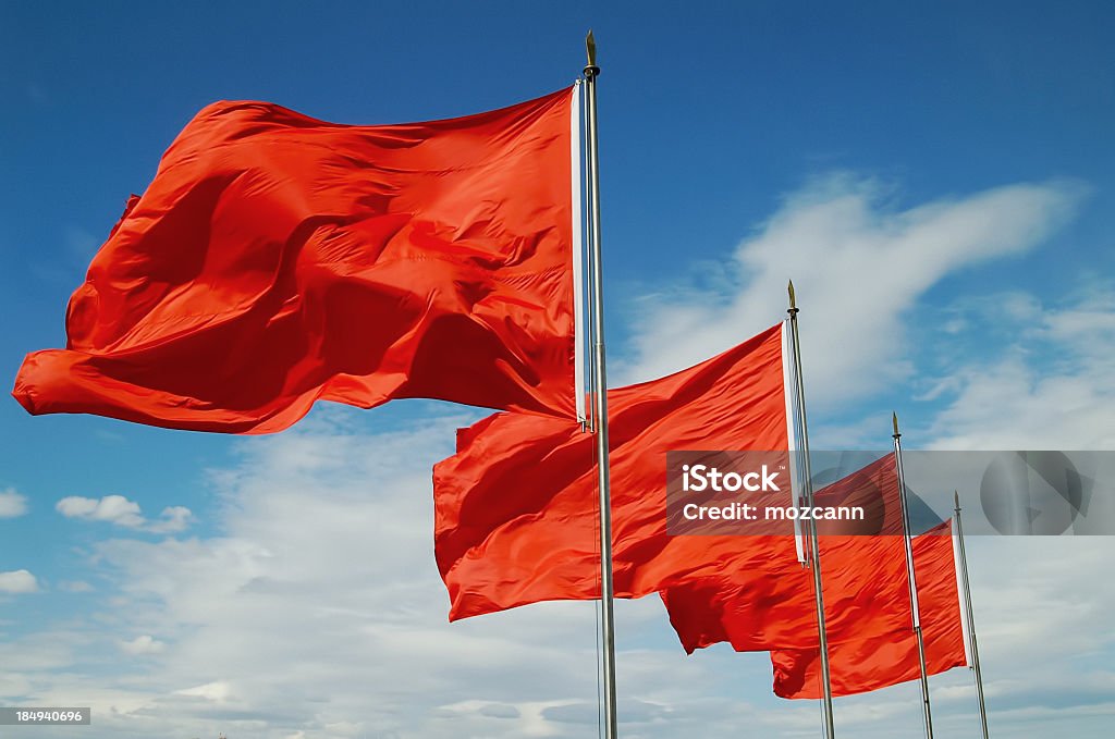 A row of red flags blowing in the wind Red Flags Flag Stock Photo