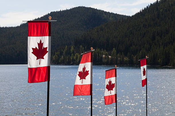 istock Canadian Flags with lake in background 184940837