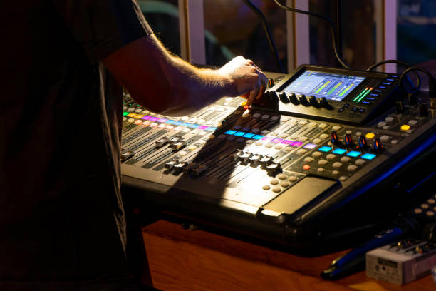 istock unrecognizable sound technician adjusting levels on a multitrack mixing console in the control room during an event 1849410697