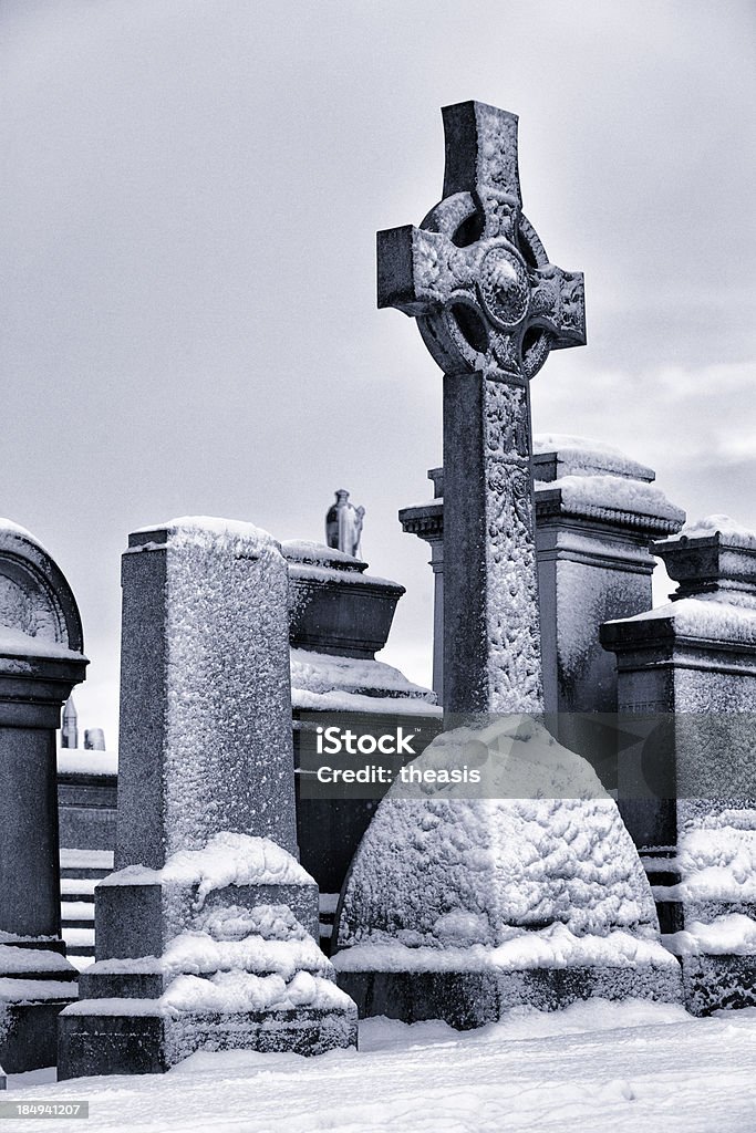 Victorian Graves Gravestones in Glasgow's Victorian Necropolis cemetery on a winter's day. Snow on the ground. Black And White Stock Photo