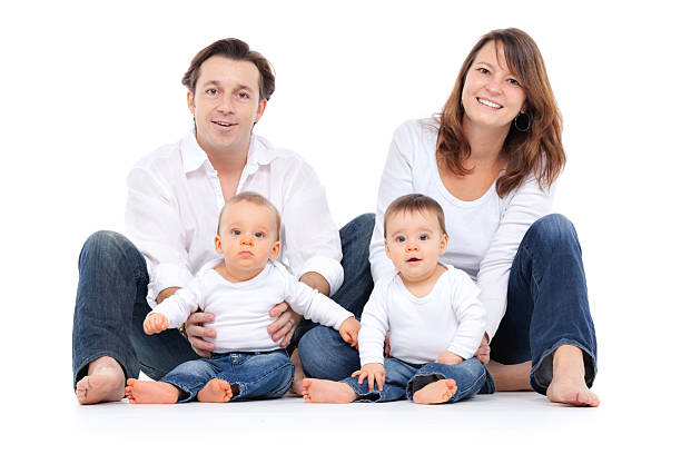 Happy family enjoying with kids in the bedroom.