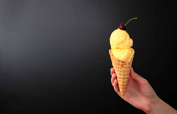 istock French Vanilla Ice Cream Cone on Black 184941431