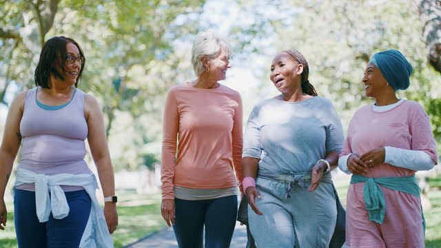 Women, friends and walking together for exercise, funny conversation and laughing for comedy. Happy diversity people, outdoors and fitness for health and wellness, speak and crazy gossip or support