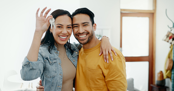 Love, keys and excited with couple in new house for moving, real estate and investment. Property, happy and future with portrait of man and woman at home for opportunity, success or marriage together