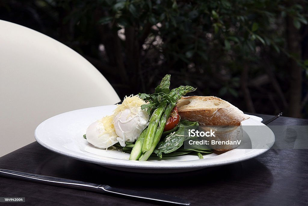 Gourmet lunch or dinner "A delicious plate of eggs, asparagus, lettuce, Parmesan cheese and bread." Asparagus Stock Photo