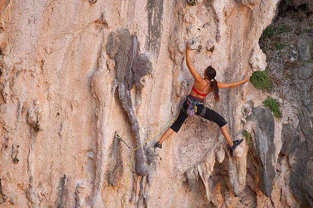 Woman rockclimbing stock photo