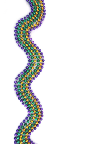 Mardi Gras Beads in a wave pattern form a border