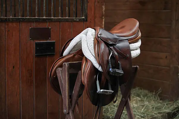 "Brown English Saddle Indoors. Stables, Concepts of Horse Back Riding."