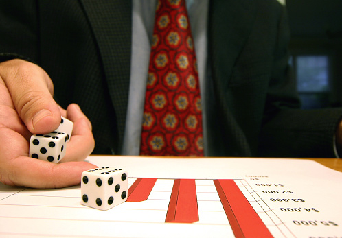 a businessman rolling dice on a chart