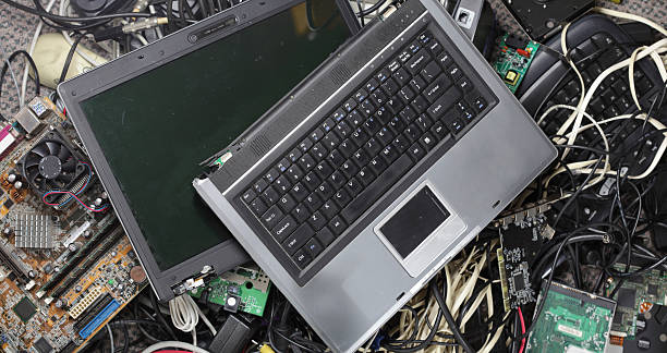 Electronic Waste Broken laptop computer on a pile of electronic waste recycling computer electrical equipment obsolete stock pictures, royalty-free photos & images