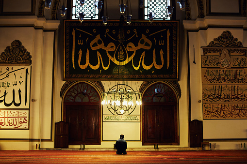Young muslim man praying in the Great Mosque