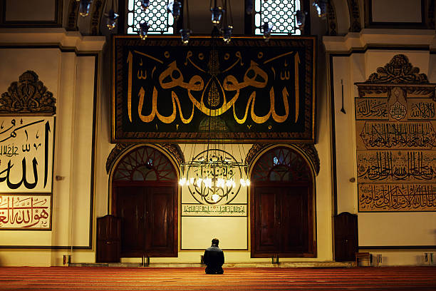 Prayer Young muslim man praying in the Great Mosque salah islamic prayer photos stock pictures, royalty-free photos & images