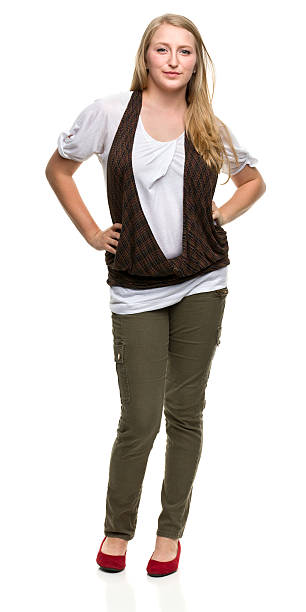 Serious Young Woman Standing With Hands on Hips