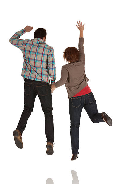istock Rear view of a couple jumping 184943750