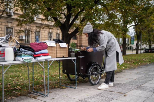 istock Woman writing prices while selling second hand items on street flea market 1849442054