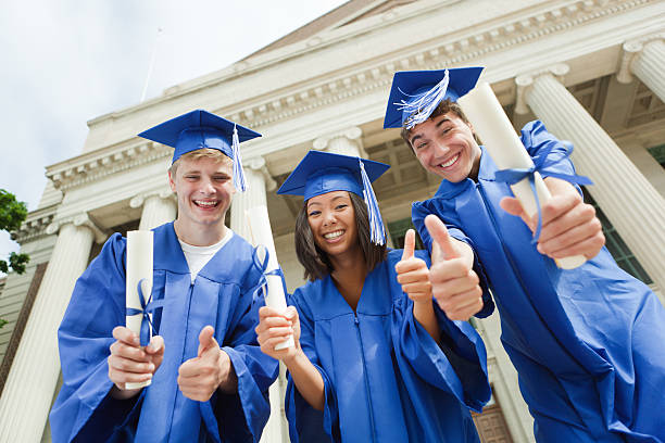 istock High School Students Celebrating Graduation with Diploma in Hands 184944688