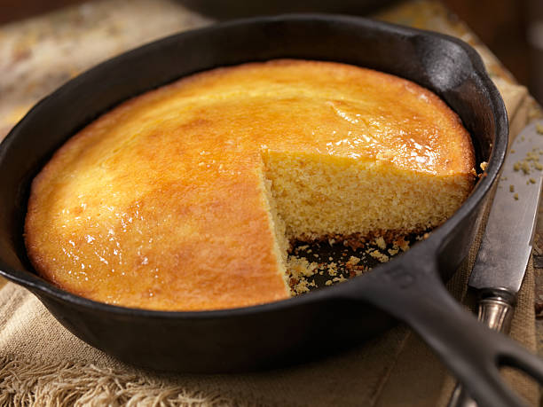 Corn Bread in a Cast Iron Skillet Corn Bread in a Cast Iron Skillet with a Pot of Baked Beans-Photographed on Hasselblad H3D2-39mb Camera Cornbread stock pictures, royalty-free photos & images