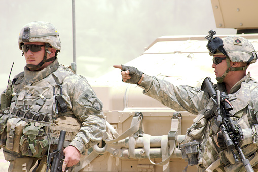 A U.S. Army Staff Sergeant (SSG) directs soldiers. 