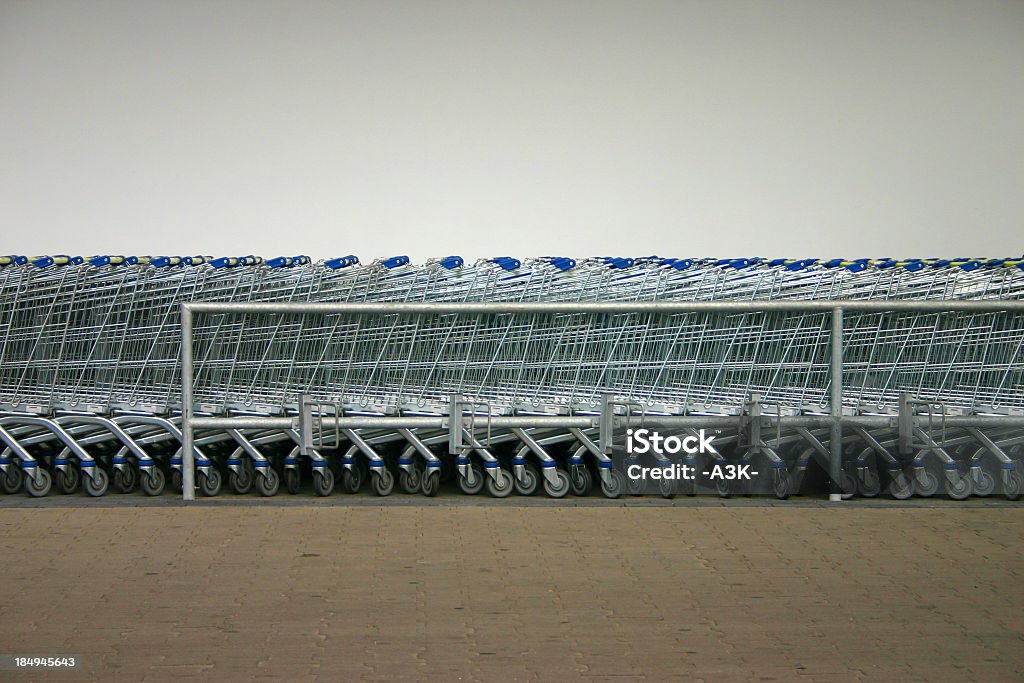 Long row of Shopping carts in a supermarket row of shopping carts In A Row Stock Photo