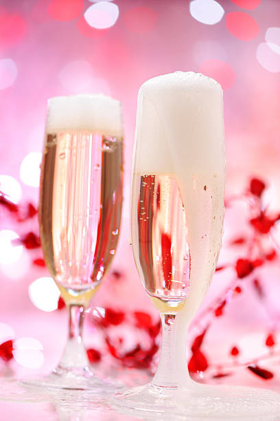 flautas de champán en fondo iluminado - champagne pink bubble valentines day fotografías e imágenes de stock