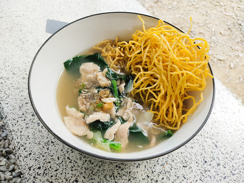 Crispy Noodles in Gravy in a bowl on the table.