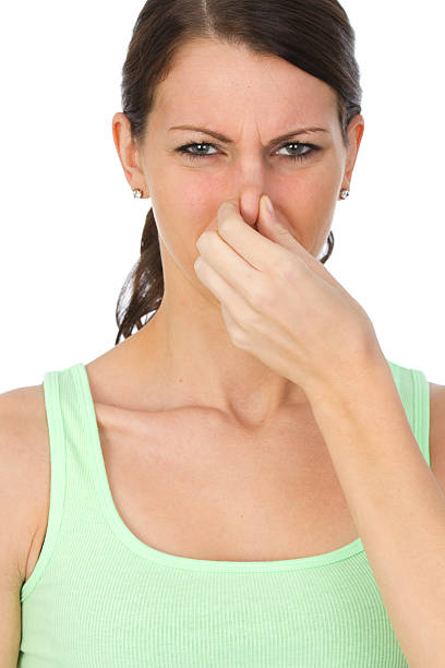 istock woman holding her nose 184946852