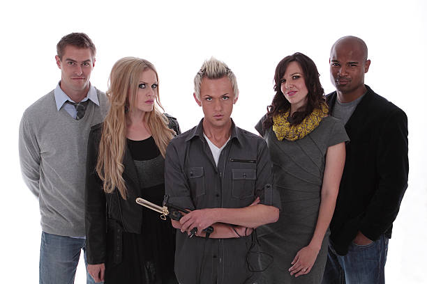 Models stand behind their hair stylist/make up artist.