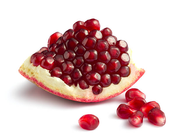 Piece of pomegranate Piece of pomegranate on white backgroundOther fruits and berries: pomegranate stock pictures, royalty-free photos & images