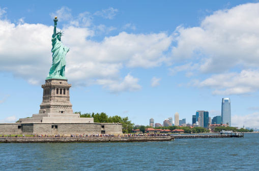 Statue of Liberty and  buildings of Jersey City in the background