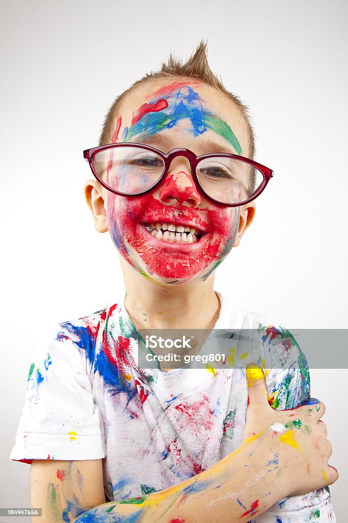 Boy having fun with finger paint Child Stock Photo