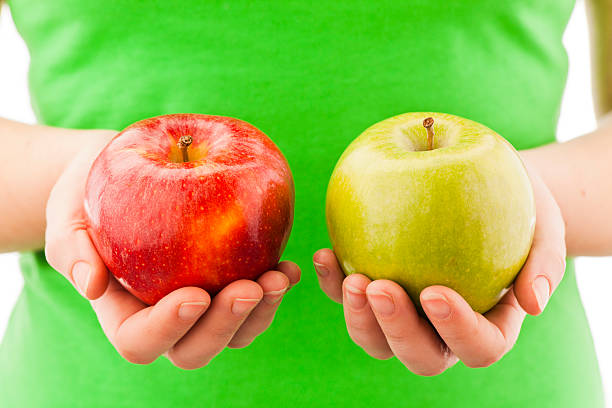 istock A person holding two apples in their hands 184947825