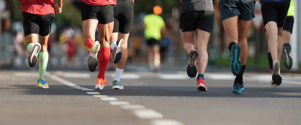 istock Marathon runners running on city road 1849480990