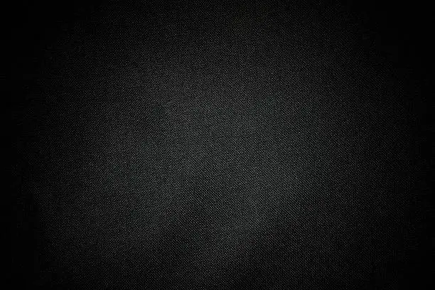 Close-up of dark texture background of black canvas.