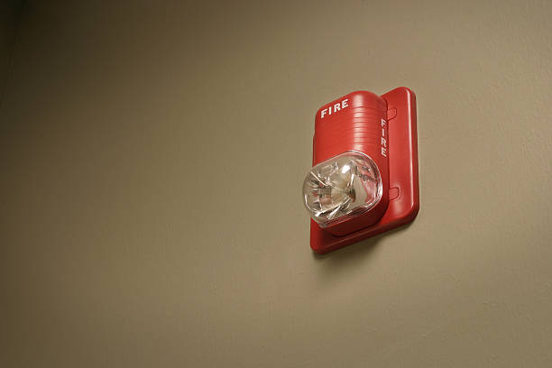 Fire Alarm Strobe A fire alarm strobe - part of a commercial fire alarm system fire alarm smoke detector smoke danger stock pictures, royalty-free photos & images