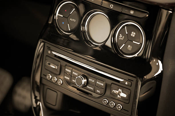 car interiour "car interiour , part of the middle console with air condition control, toned image" regler stock pictures, royalty-free photos & images