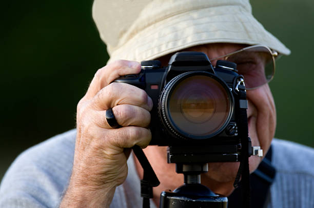istock Senior Male Photographer close up with camera 184948863