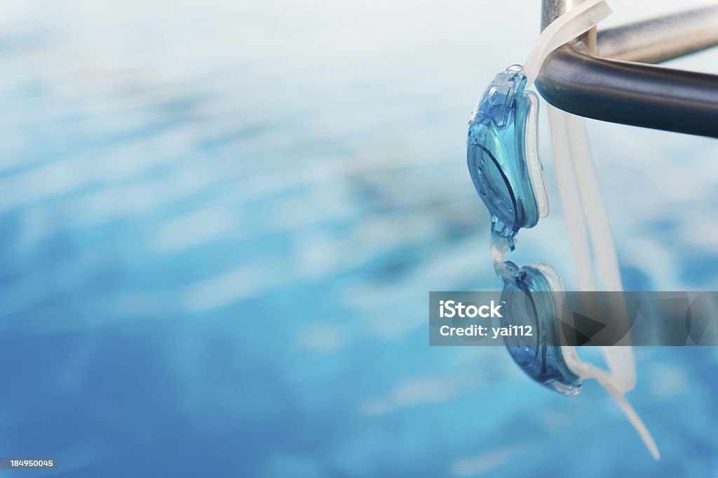 swimming goggles swimming goggles hangs on starting block. Activity Stock Photo