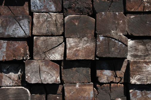 Ends of stacked Railroad Ties.  Treated wood textures.