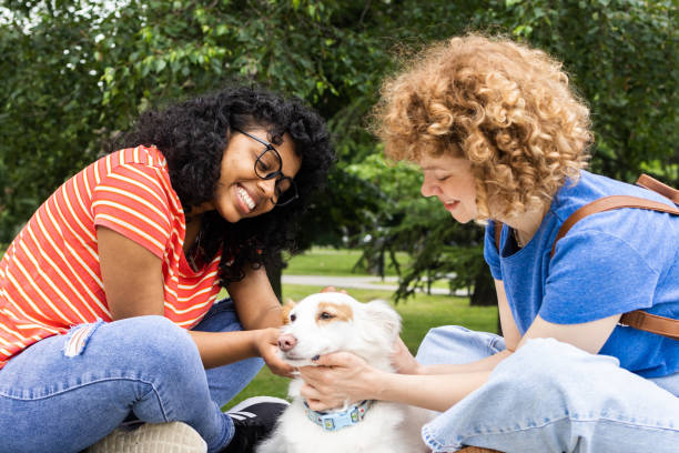 istock Two young women spend their free time with their dog 1849514136